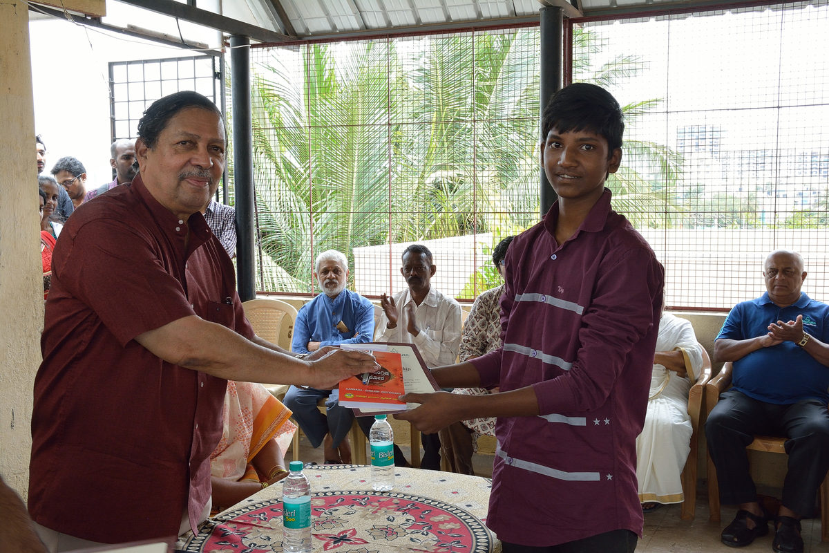 A scholarship being handed to a student