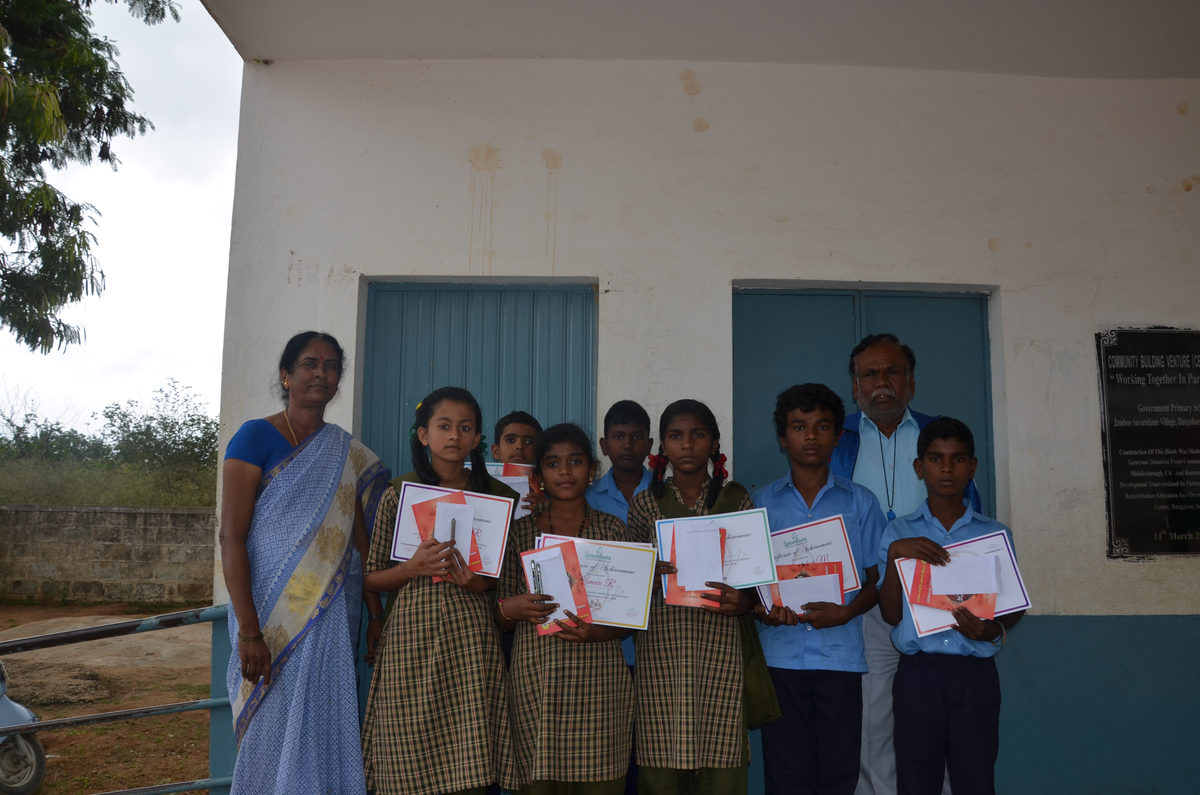 Students with scholarship certificates outside their school